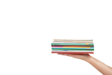 Different colorfull books in stack with hand isolated on white background, copy space template