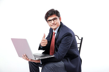 Young Indian businessmen using laptop over isolated background.
