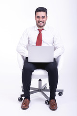Businessman sitting on white chair isolated.