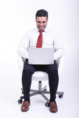 Businessman sitting on white chair isolated.