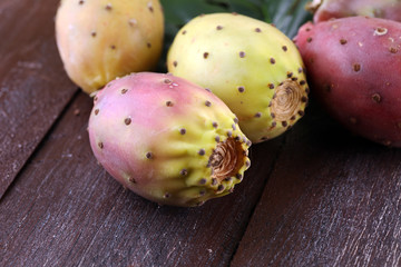 Fruits of the prickly pear cactus on a rustic table.