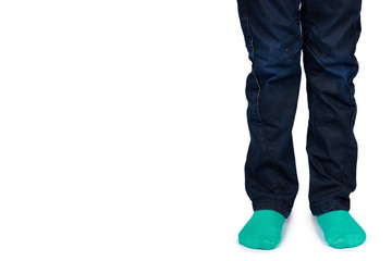 Fototapeta premium Kid legs in colored socks on leg isolated on white background, copy space template