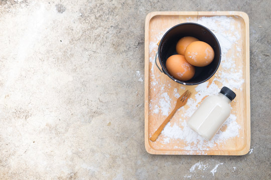 Raw fresh egg milk on wooden tray
