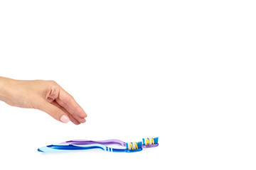 Color new toothbrush with hand isolated on a white background, copy space template.