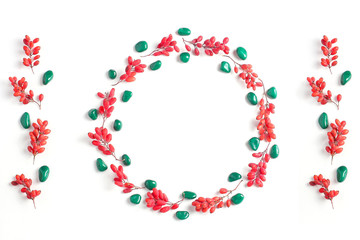 Frame of red berries on a white background. Simple flat lay composition, fall creative background