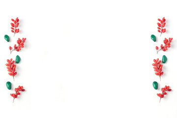 Frame of red berries on a white background. Flat lay, top view composition, fall creative background, space for a text