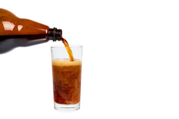 Dark brown plastic bottle of beer or kvass with glass cup isolated on a white background, copy space template.