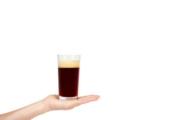 Hand with cold glass of dark beer or kvass with foam isolated on white background, copy space...