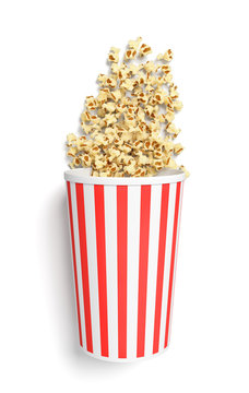 3d rendering of a round striped popcorn bucket lying on its side with popcorn spilling out of it in top view.