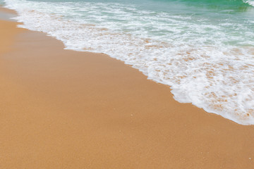 Fototapeta na wymiar soft wave of an ocean on a sandy beach