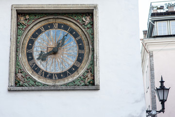 Fototapeta na wymiar The white tower and old clock in the wall in old town of Tallinn Estonia Europe