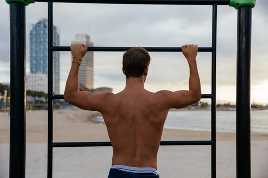 Young man training on bars.
