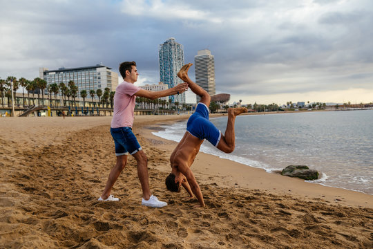 Two athletes do a handstand.