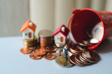Miniature people, lover standing with stack coins and mini house using as businss, family and property concept