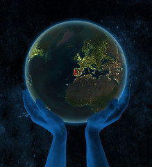 Portugal on night Earth in hands in space