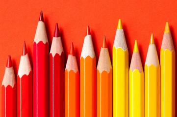 Color pencils isolated on red background.
