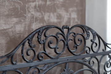 Close-up of black forged lattice for fireplace in classic style