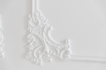 Decoration molding frame item made of white plaster. Relief stucco interior