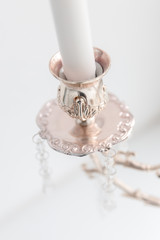 Modern antique candlestick with wax candles in classic style, white color