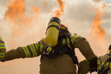 Some firemen fighting a great fire. Firefighters doing some training.