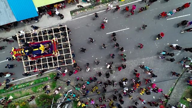 Aerial view preparation for the hindu сremation ceremony on Bali. Huge figures of animals are manually transferred to the place of the ceremony.
