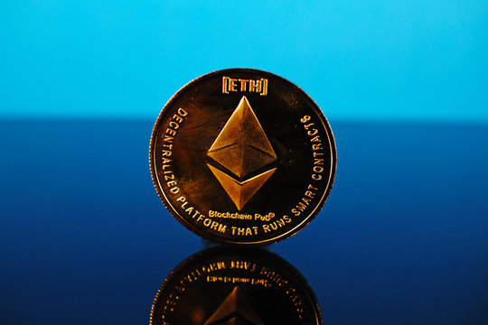 Etherum money crypto currency coin on reflective colorful background