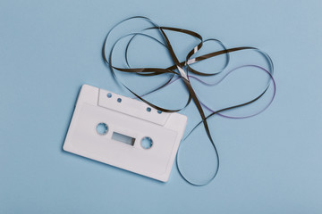 blank white compact cassette with twisted tape
