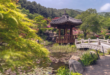 Fototapeta na wymiar korean wooden pavilion with pond and stone bridge