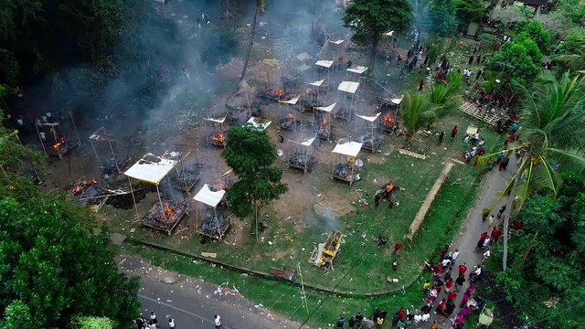 Aerial view hindu сremation ceremony on Bali. Human remains are burned in animal figures.