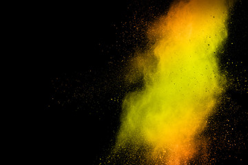Abstract explosion of orange dust on white background. Freeze motion of orange dust splashing.