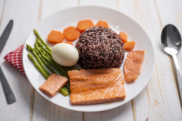 Health food concept, salmon with rice and vegetable on wood background