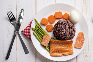 Health food concept, salmon with rice and vegetable on wood background