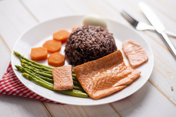 Health food concept, salmon with rice and vegetable on wood background