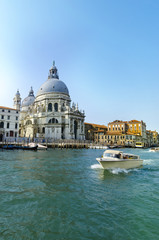 Fototapeta na wymiar Yacht boat on Grand Canal and Basilica Santa Maria della Salute, Venice, Italy