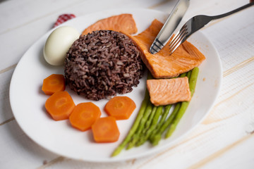 Health food concept, salmon with rice and vegetable on wood background