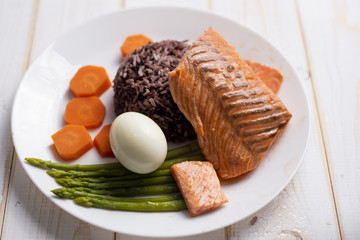 Health food concept, salmon with rice and vegetable on wood background