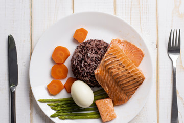 Health food concept, salmon with rice and vegetable on wood background