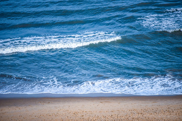 Aerial above view of Waves Ocean sea yellow sandy beach.