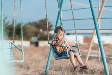 Child on a swing near the sea