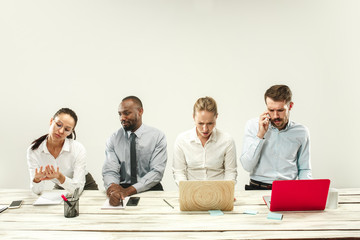 Young african and caucasian men and women sitting at office and working on laptops. The business, emotions, team, teamwork, workplace, leadership, meeting concept. different emotions of colleagues