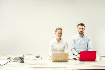 Young african and caucasian men and women sitting at office and working on laptops. The business,...