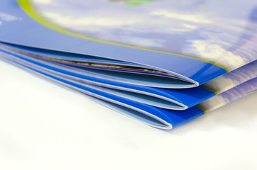 Stack of magazines, brochures, isolated on a white background.