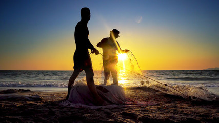 Silhouette Fishermen using fishing nets, fishing with nets in the morning sunrise, cinematic