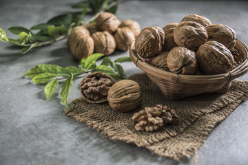 Walnuts in wooden bowl. Whole walnut on table