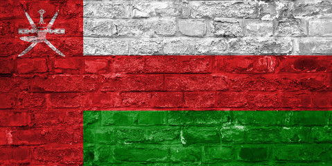 Flag of Oman over an old brick wall background, surface