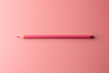 pink crayon pencil on pink paper background. - Business concept