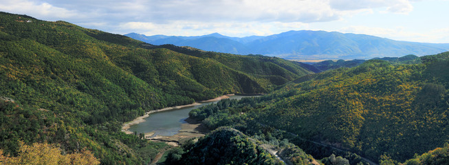 Panorama of mountain landscape with small lake in valley