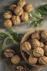 Walnuts in wooden bowl. Whole walnut on table