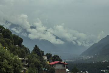 Fototapeta premium fog and clouds in mountain and village