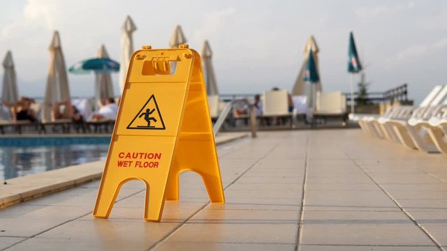 Watch For Slippery Tile Floor Yellow Warning Sign Background LOOP